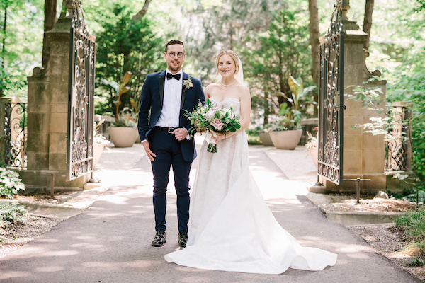 bride and groom standing inside the garden gates at Newfields in Indianapolis