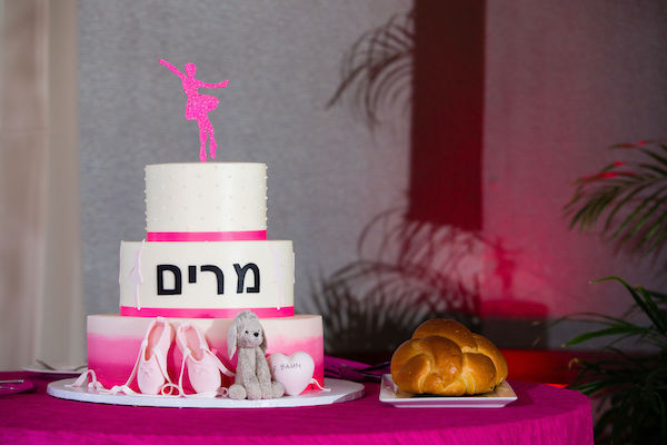 three-tiered white and to pink dance themed Bat Mitzvah cake with a sugar replica of Kyra's stuffed animal