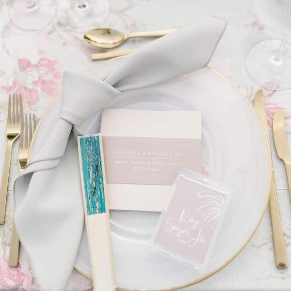 place setting with gold flatware, milk ware charger plate and custom stationery