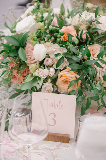 floral centerpiece and table number at a Newfields outdoor wedding reception
