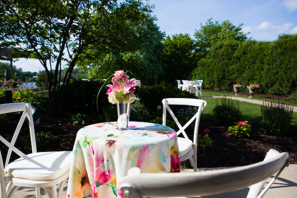Outdoor cocktail tables with floral linen and pink flowers at Montage event venue in Indianapolis