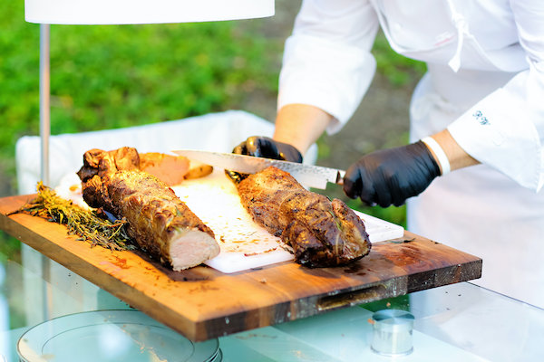 Chef Roger Watson carving a pork loin at a luxurious Indianapolis wedding