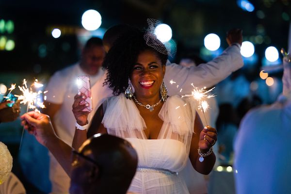 woman holding a sparkler at the 2021 Indianapolis Diner en Blanc on the White Street Bridge