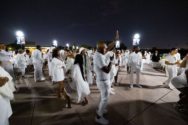 guest dancing on the White Street Bridge, location of the 2021 Indianapolis Diner en Blanc