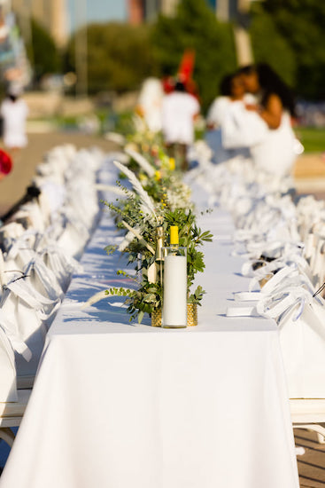 Indianapolis Diner en Blanc tables lined with floral decor and tote bags