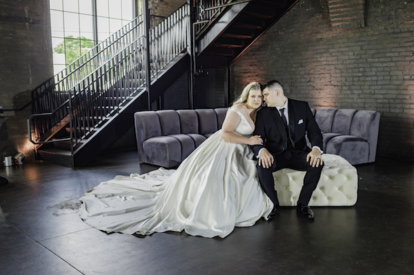 Ft Wayne bride and groom sitting in a unique industrial wedding venue