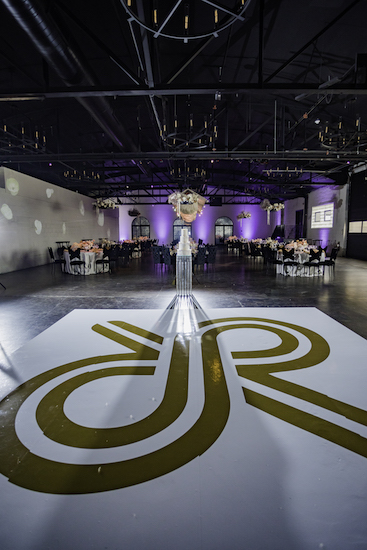 Custom dance floor and reception at a fantasist Ft Wayne wedding in a rustic industrial space