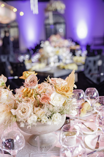 floral centerpiece in white and soft pinks mixing industrial decor with softer tones
