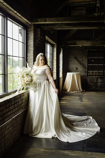 bride standing by the window of a Ft Wayne industrial wedding venue