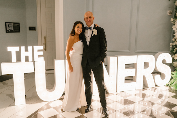 Bride and groom in front of large custom letters at their Hotel Carmichael wedding