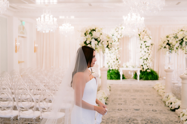 bride waiting for her groom for their first look in the ballroom at the Hotel Carmichael
