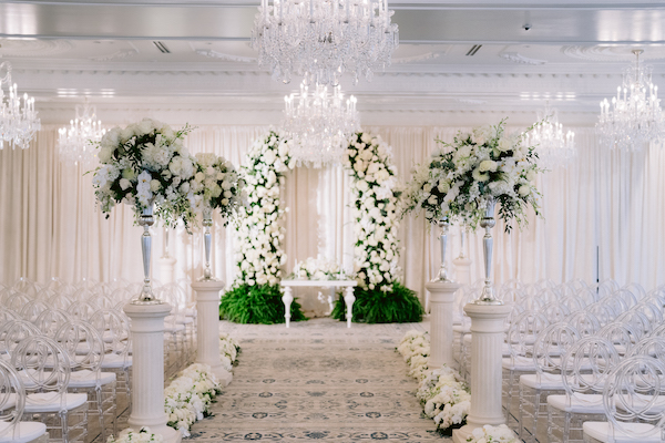 luxurious white wedding ceremony decor in the ballroom of the Hotel Carmichael in Carmel Indiana