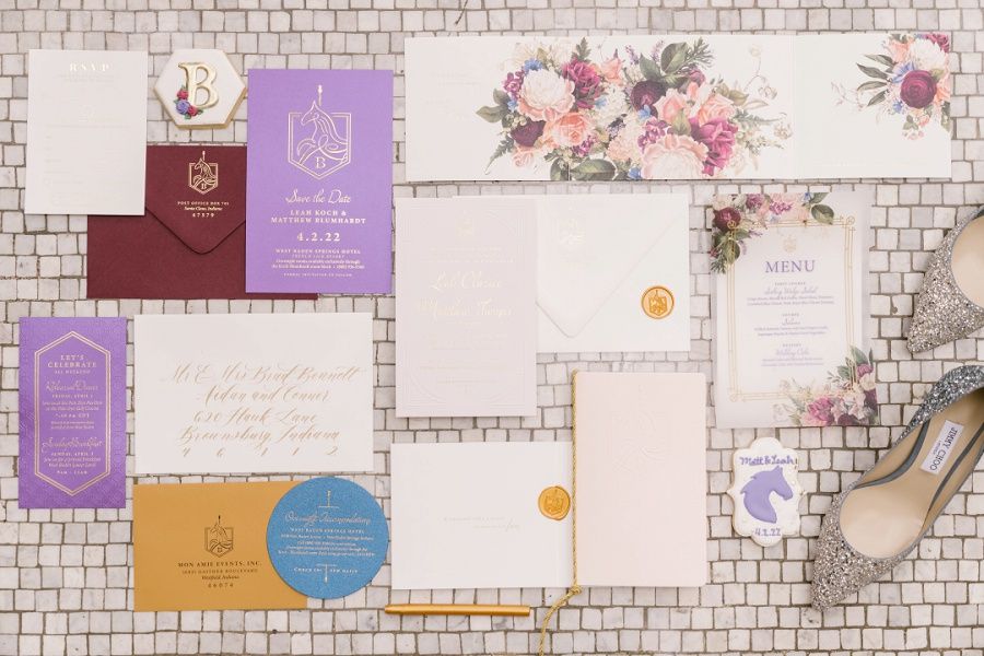 Custom wedding invitations for a luxurious west baden springs wedding showcaing the couple's carousel horse monogram