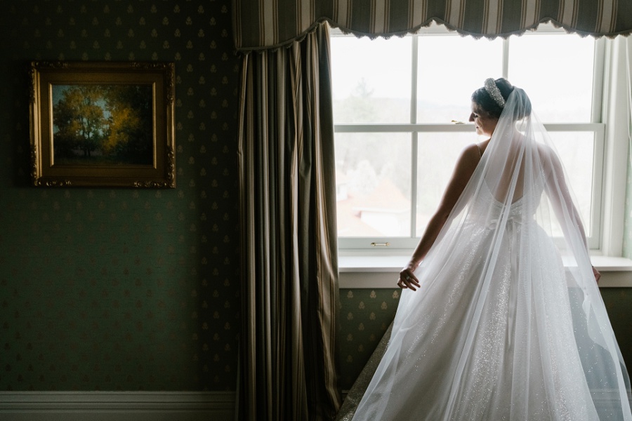 beautiful bride at the window of her West Baden Springs Hotel suite