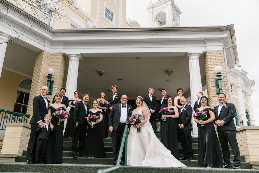 bride and groom with thier wedding party outside of the West Baden Springs Hotel at the French Lick Resort