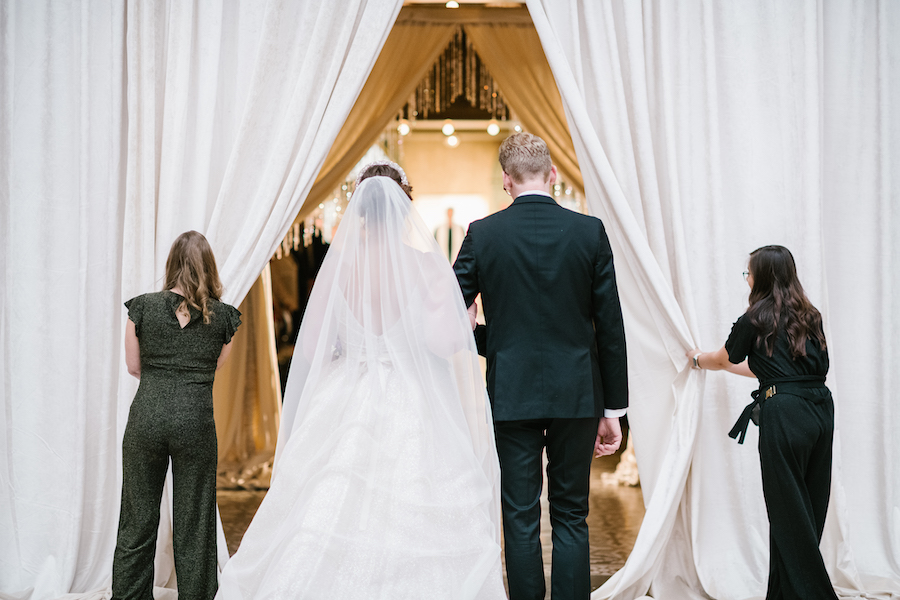 bride, escorted by her brother prepare to walk down the aisle at her West Baden wedding ceremony