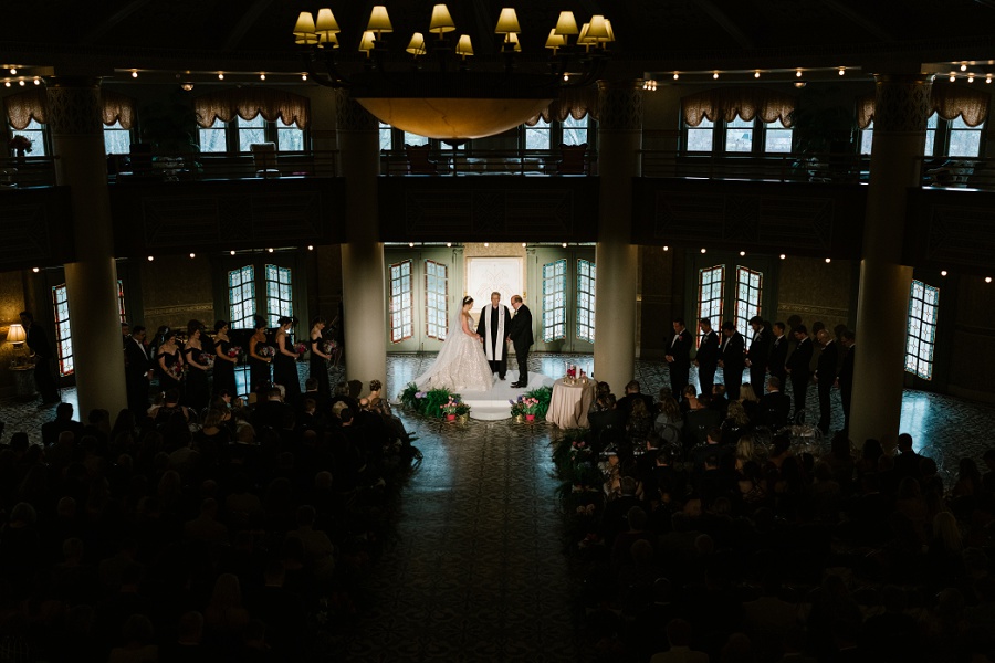 bride and groom exchanging wedding vows during a ceremony at the West Baden Springs Hotel