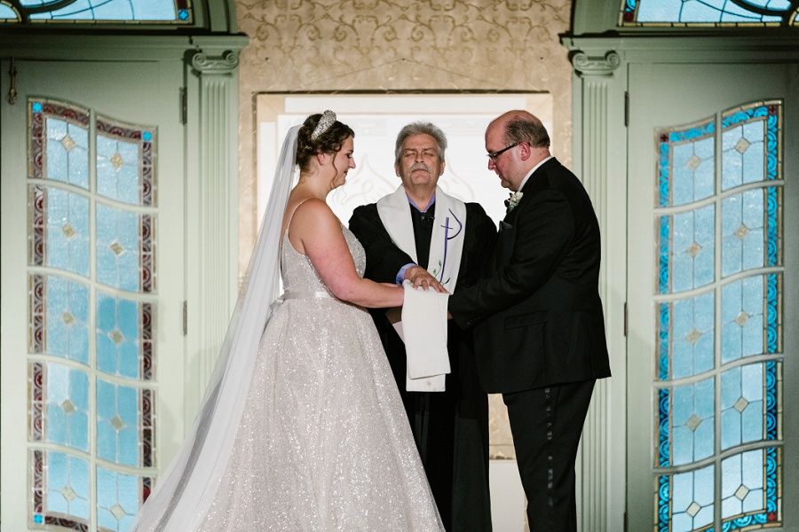 bride and groom exchanging wedding vows during a ceremony at the West Baden Springs Hotel