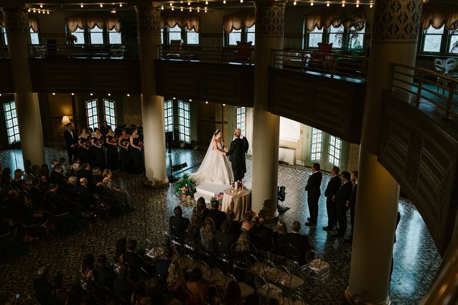 bride and groom exchanging wedding vows during a ceremony at the West Baden Springs Hotel