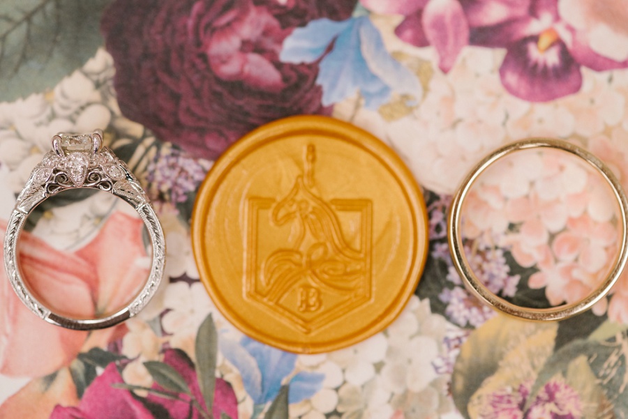 gold wax seal with the bride and groom's custom carousel horse monogram
