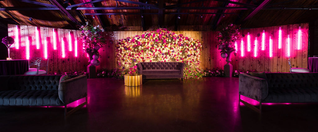 lush wall of earl grey roses transformed into a backdrop for dancing and lounge area