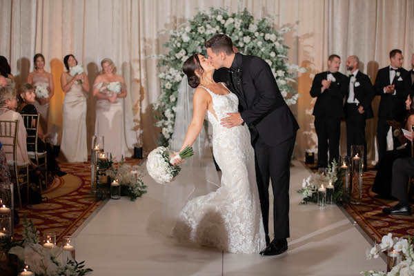 Bride and groom sealing their wedding vows with a kiss