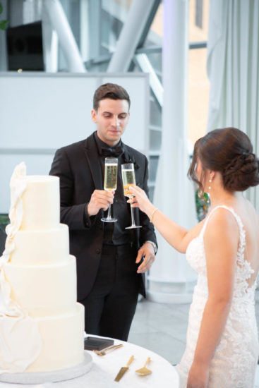 Indianapolis bride and groom toasting before cutting their wedding cake