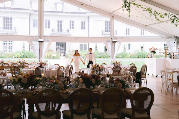 bride and groom taking a sneak peek at their wedding reception