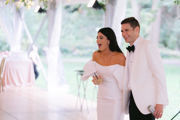 excited bride and groom after seeing their wedding reception decor