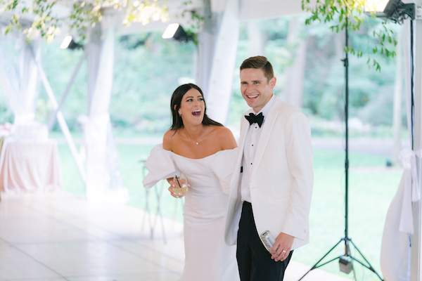 excited bride and groom after seeing their wedding reception decor