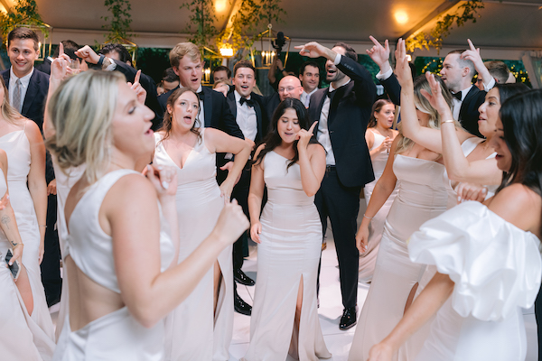 bride and groom dancing with their wedding party