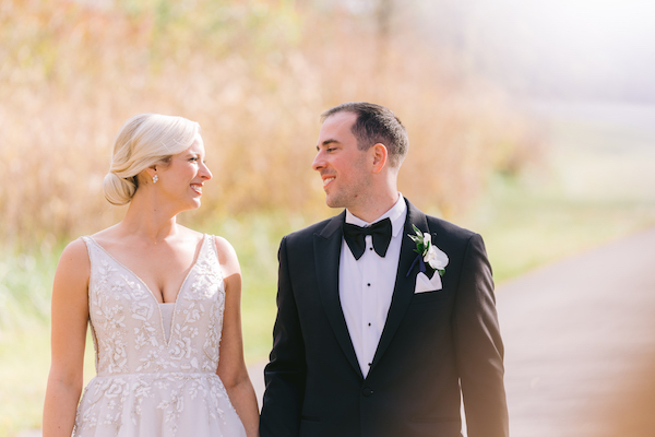 Smiling bride and groom out for a walk in the country