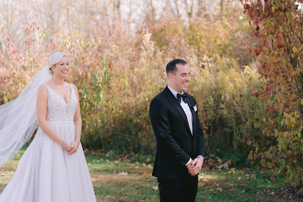 bride walking up behind her groom-to-be