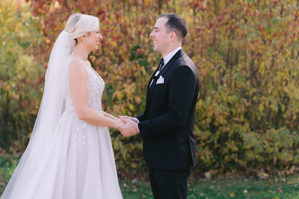 bride and groom holding hands after first look