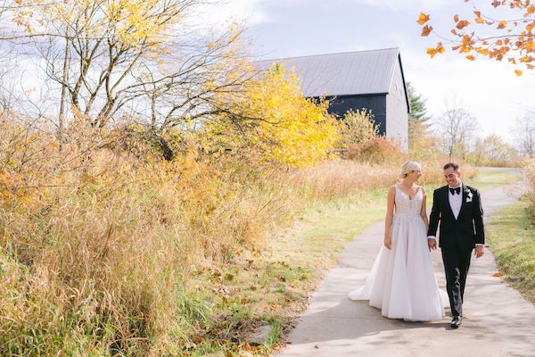 Indianapolis bride and groom walking through the countryside