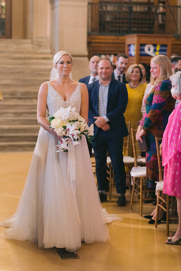 emotional bride walking down the aisle at the Indianapolis Central Library