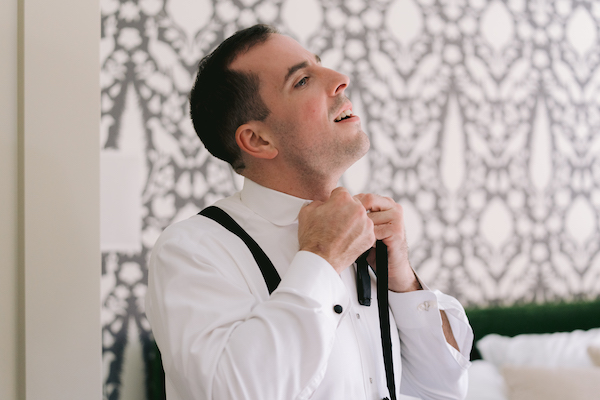 Groom fixing his tie