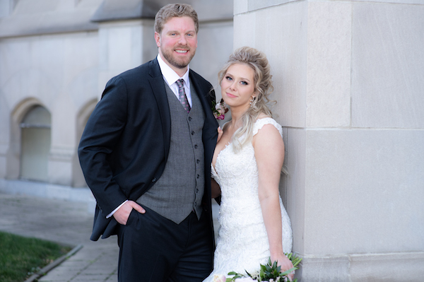 Bride and groom pose for wedding photos outside the Scottish Rite Cathedral