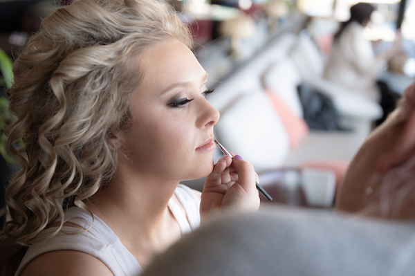 Indianapolis bride getting makeup done on her wedding day