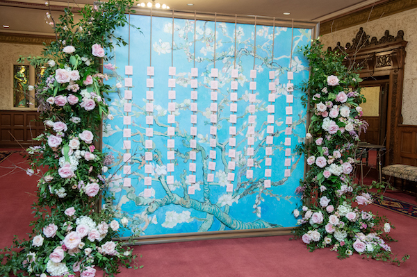 Escort card wall that doubles as a photo backdrop