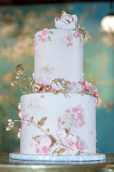 Two-tiered pink and gold wedding cake