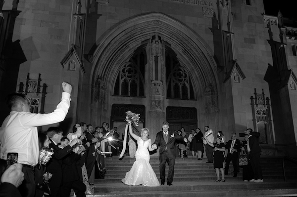 Bride and groom's grand exit after their Indianapolis wedding at the Scottish Rite Cathedral