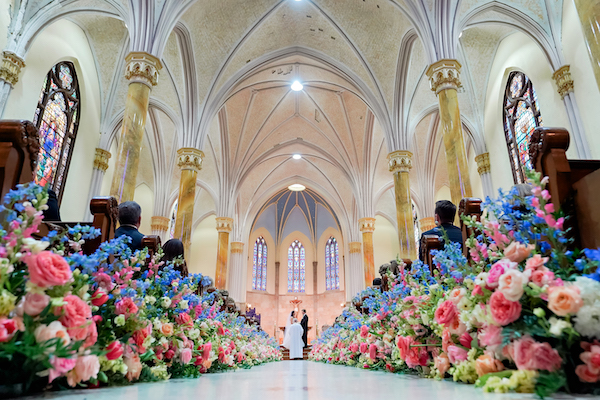 Aisle of St. Mary's in Indianapolis filled with bright colored flowers