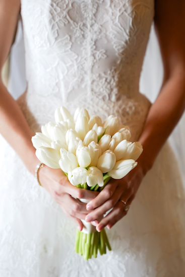 Bride holding bouquet of white tulips