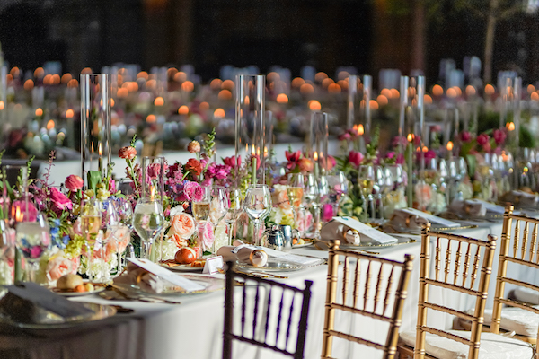 Long reception tables at a colorful wedding