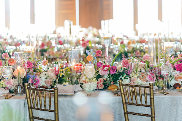 Long reception tables at a colorful wedding