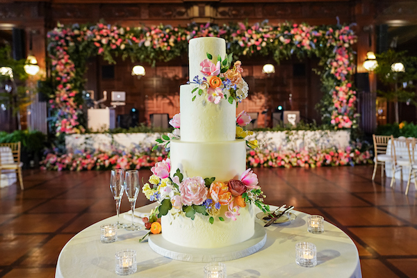 White wedding cake with colorful flowers