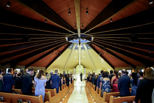 Wedding ceremony inside Our Lady of Mt. Carmel in Carmel Indiana