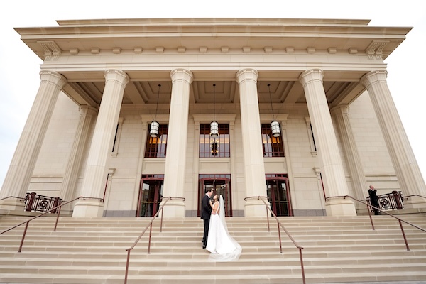 Bride and groom on the steps of the Palladium in Carmel Indiana