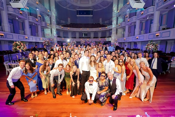 Bride and groom with all of their guests inside the concert hall at the Palladium in Carmel Indiana.